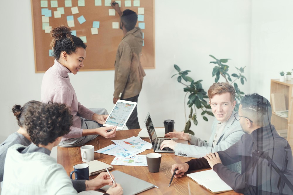 Coworkers working together around a desk