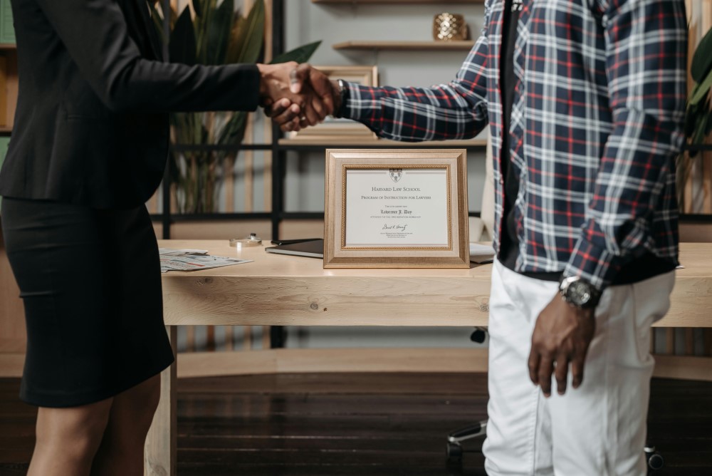 A lawyer and their client shaking hands