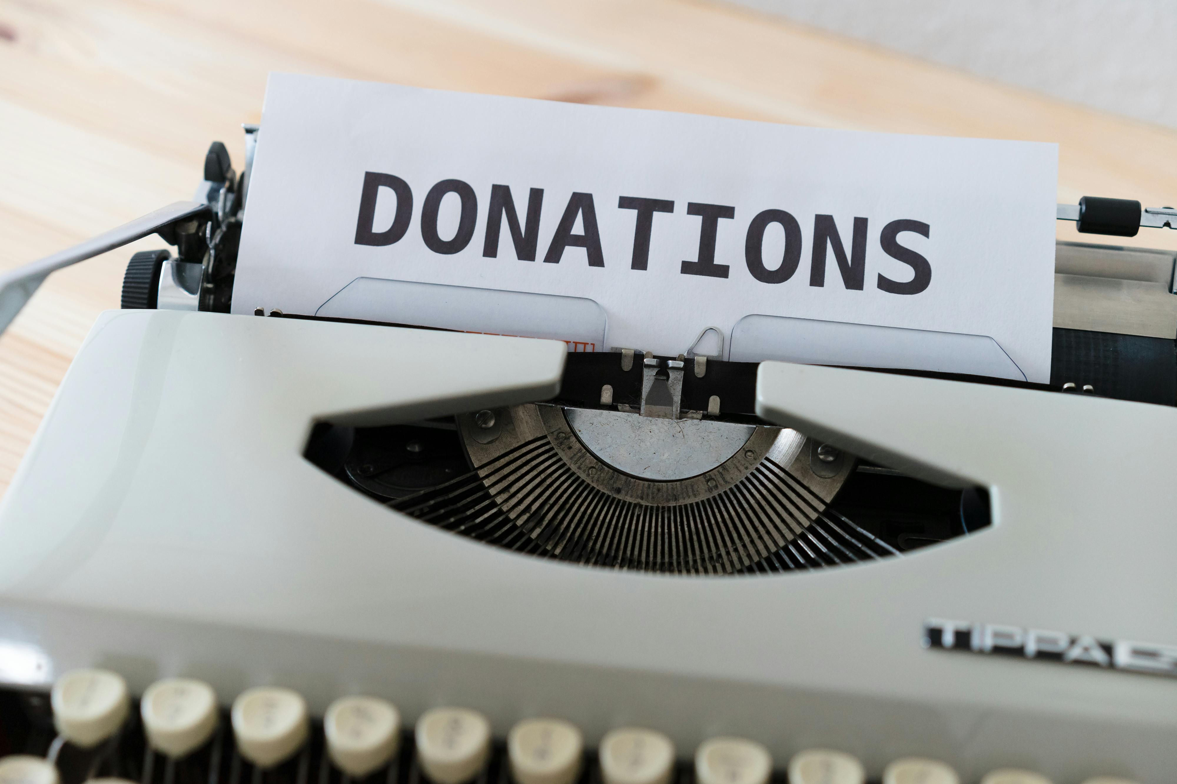 A typewriter with the word DONATIONS printed on paper