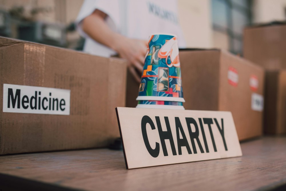 A table with different boxes and cups for charity