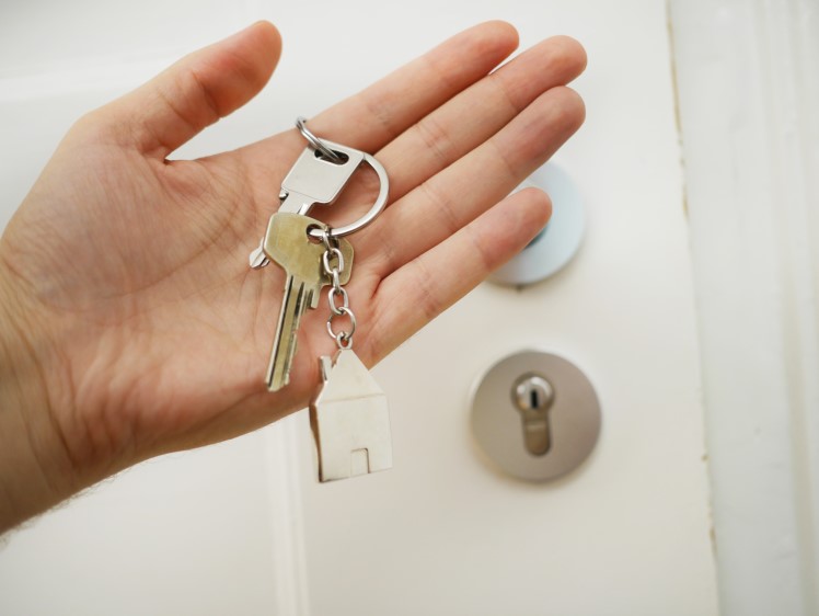 Homeowner holding keys—symbolizing the excitement of homeownership.