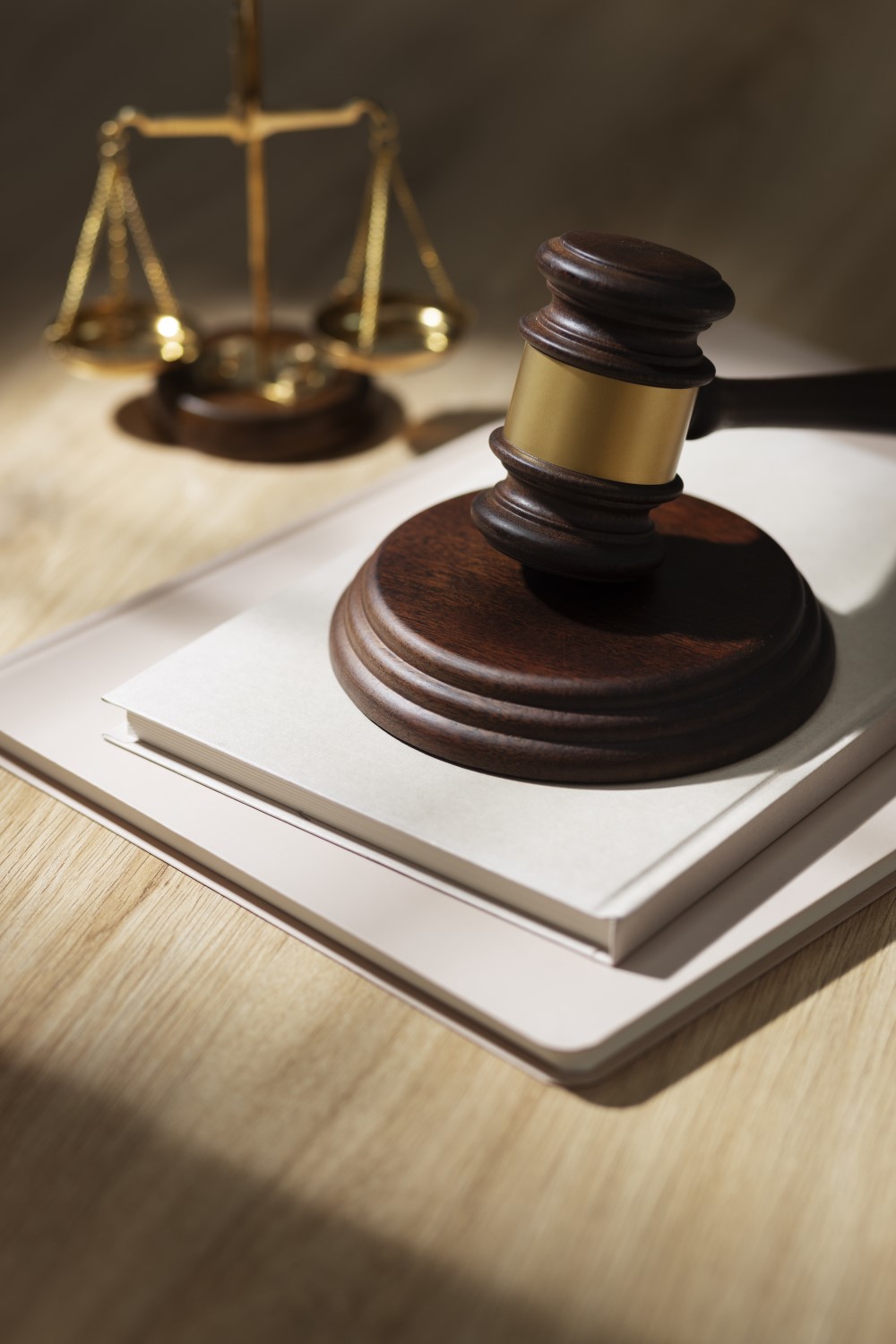 A table containing an in focus gavel in front of a blurred scale